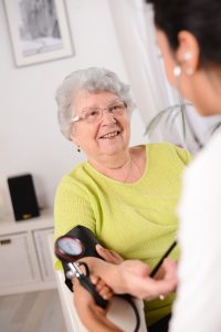 Older patient has her blood pressure checked